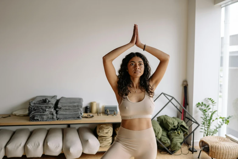 a woman is in yoga gear and stretching