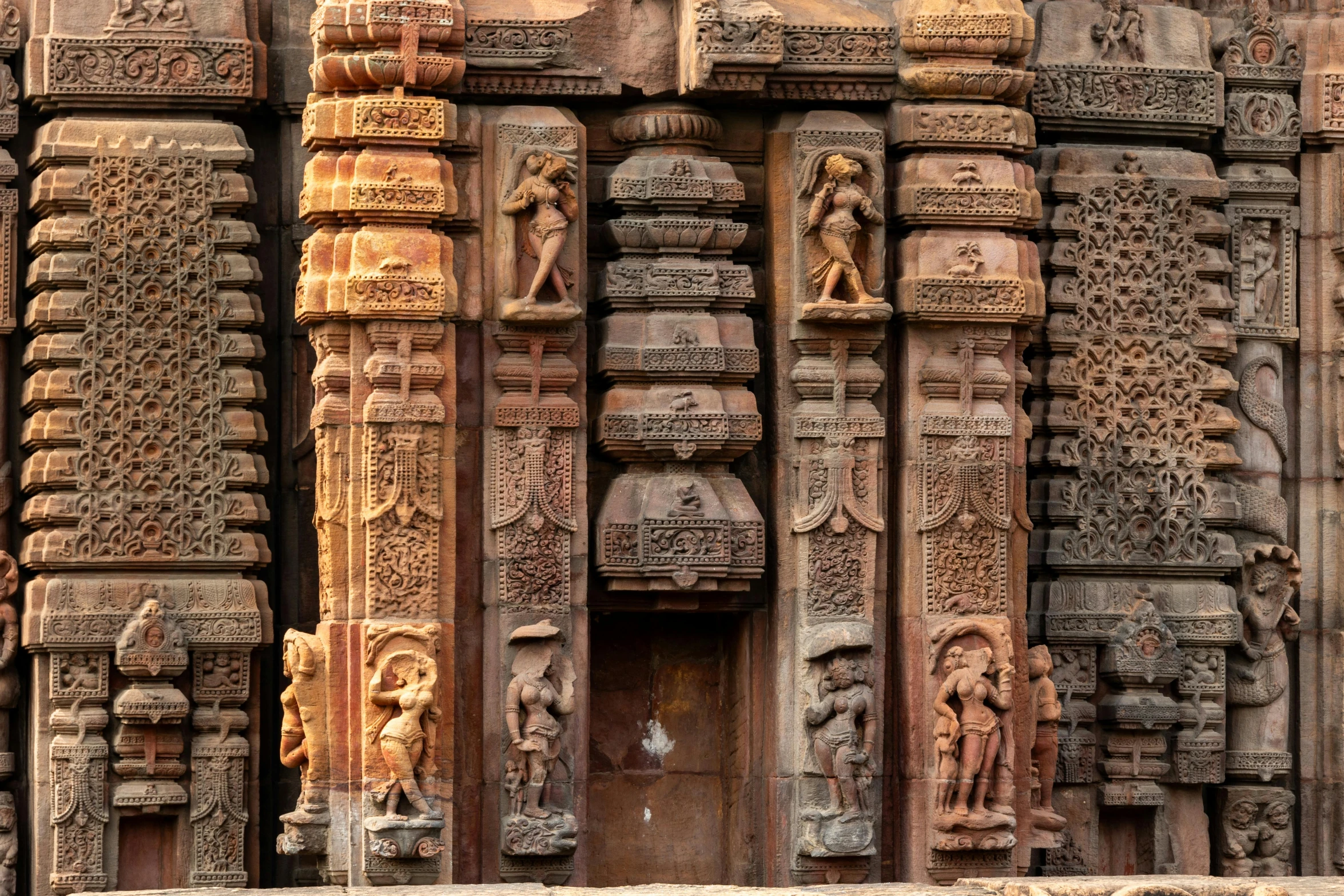 an elaborately decorated doorway and wall at a temple