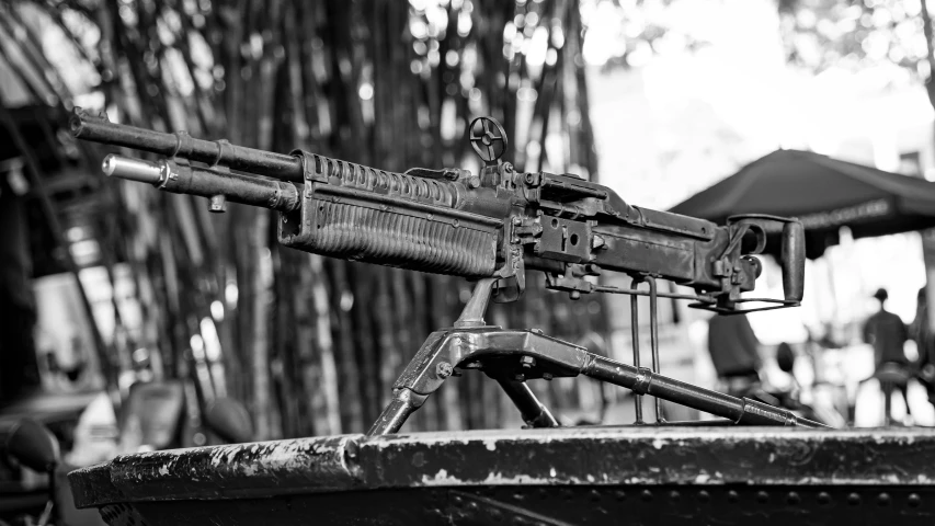 a weapon on a wooden stand in black and white