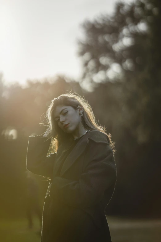 a girl is standing outside with her hands on her face