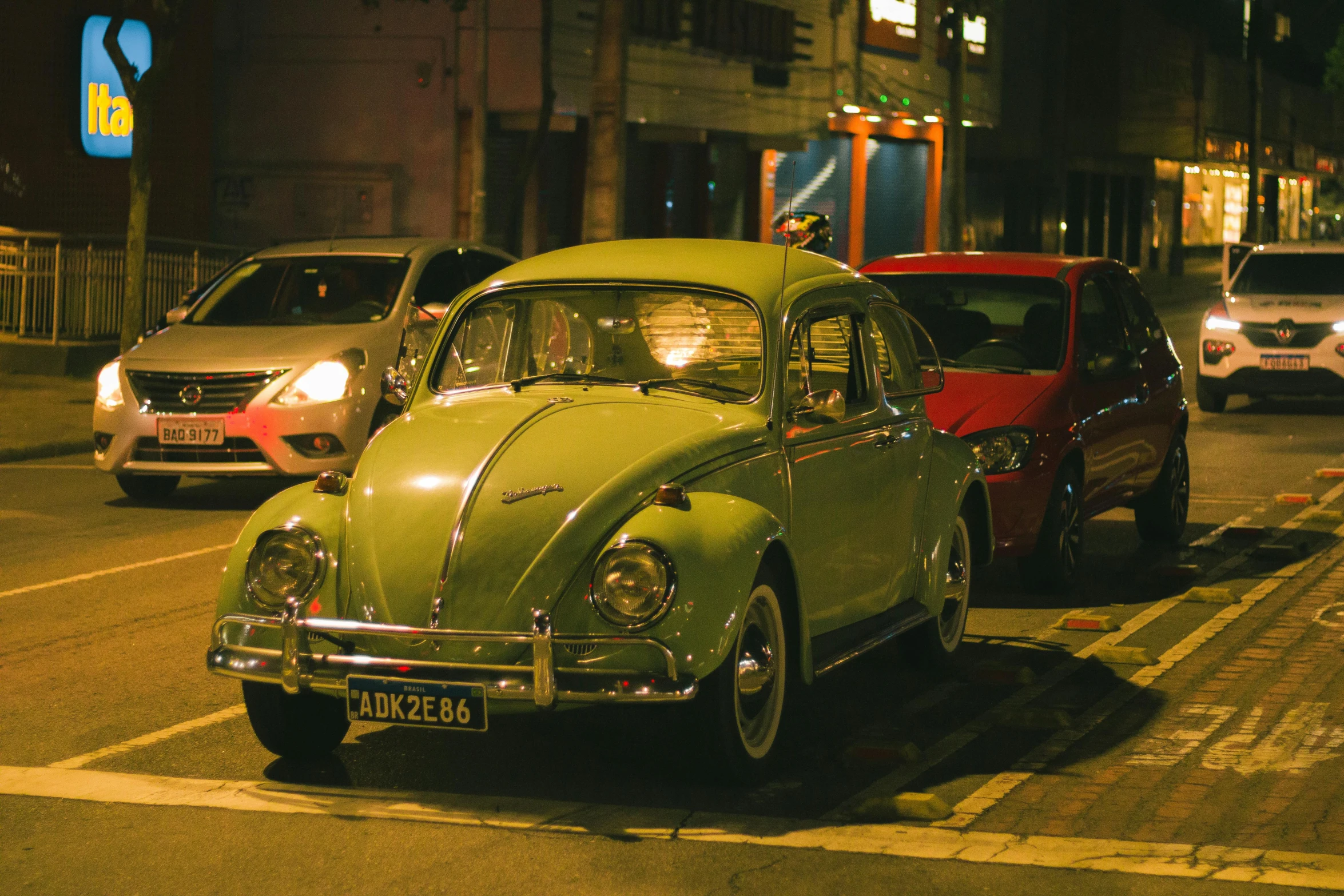 a street scene with old cars in traffic