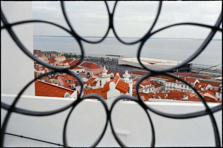 a view from a window in an apartment building over a city