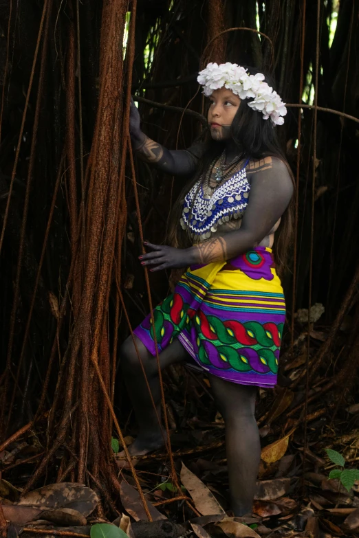 a woman dressed in a hula skirt holding a stick