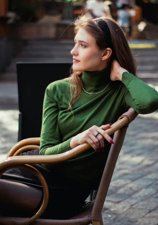 a woman sitting on a chair looking over her shoulder