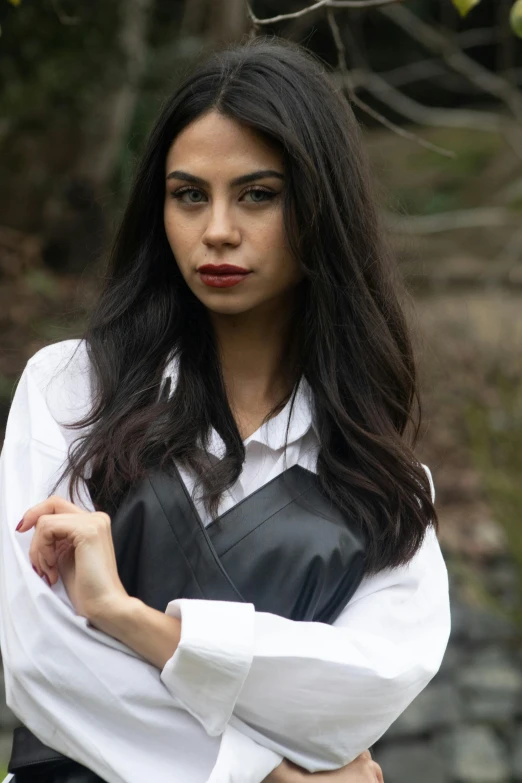 a beautiful young lady wearing a white and black top