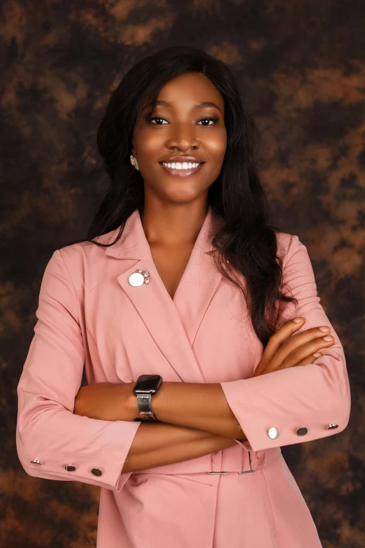 a beautiful woman in a pink suit and watch