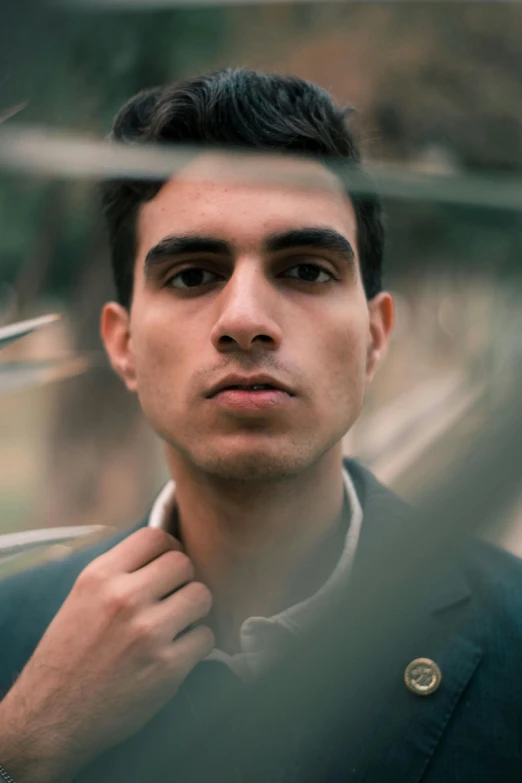 man in dark blue sweater staring with thoughtful look