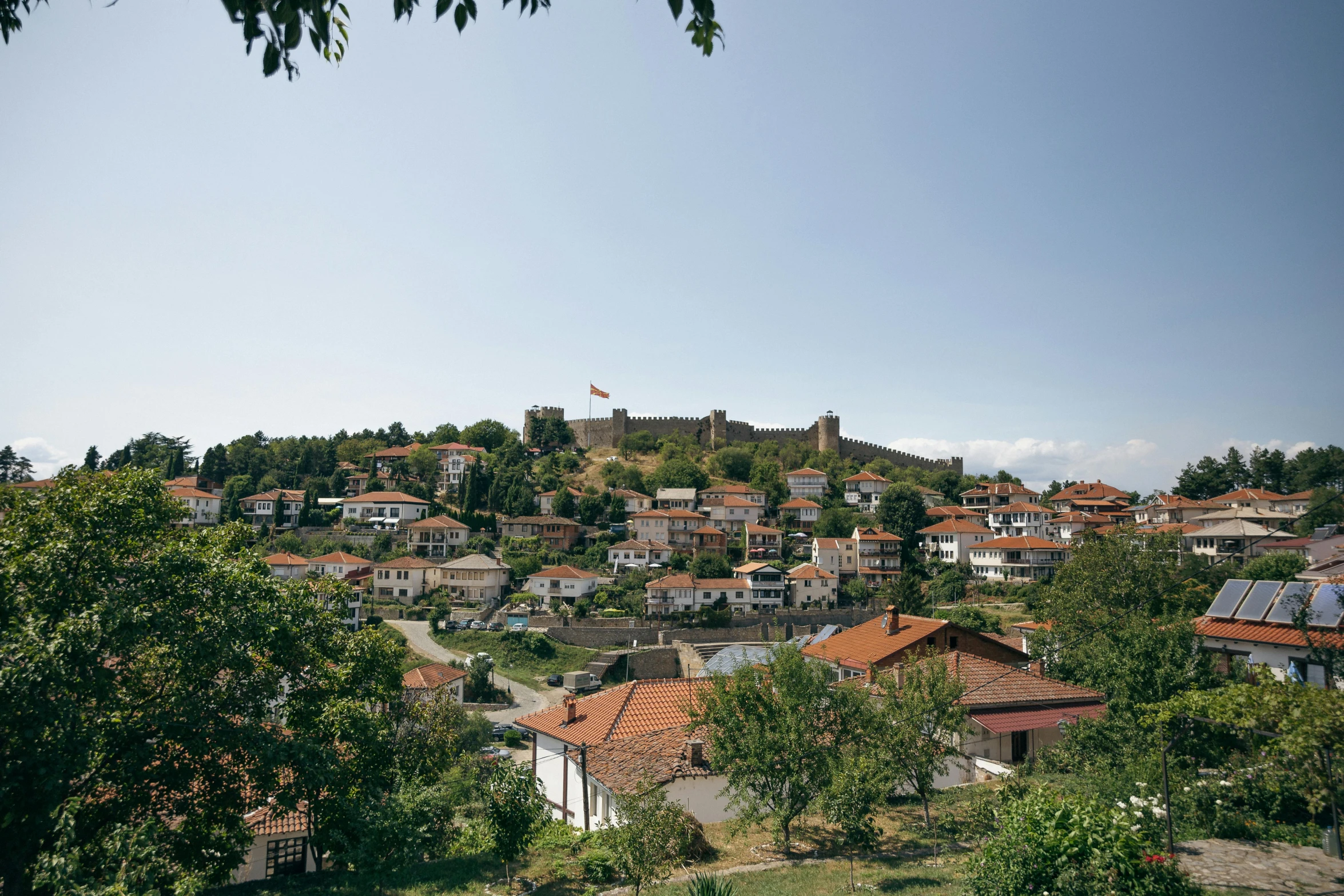 view of some buildings on a hill near some trees