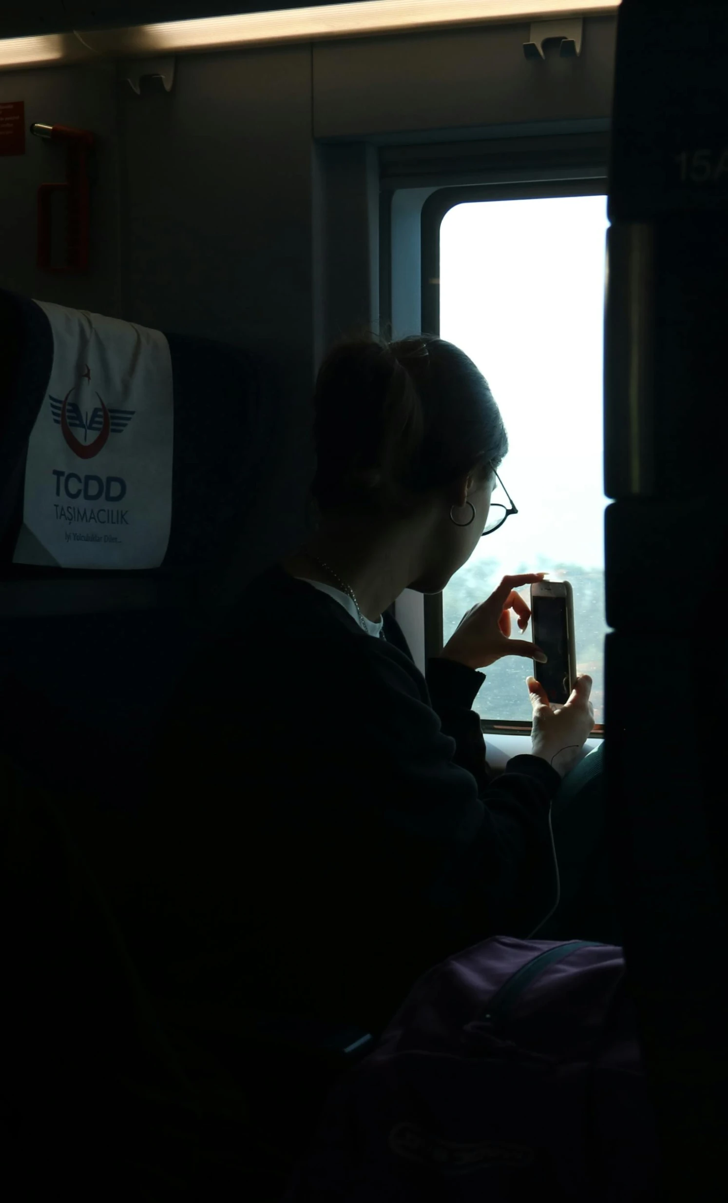 a woman on her cell phone while riding the subway