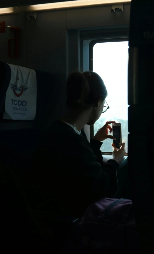 a woman on her cell phone while riding the subway