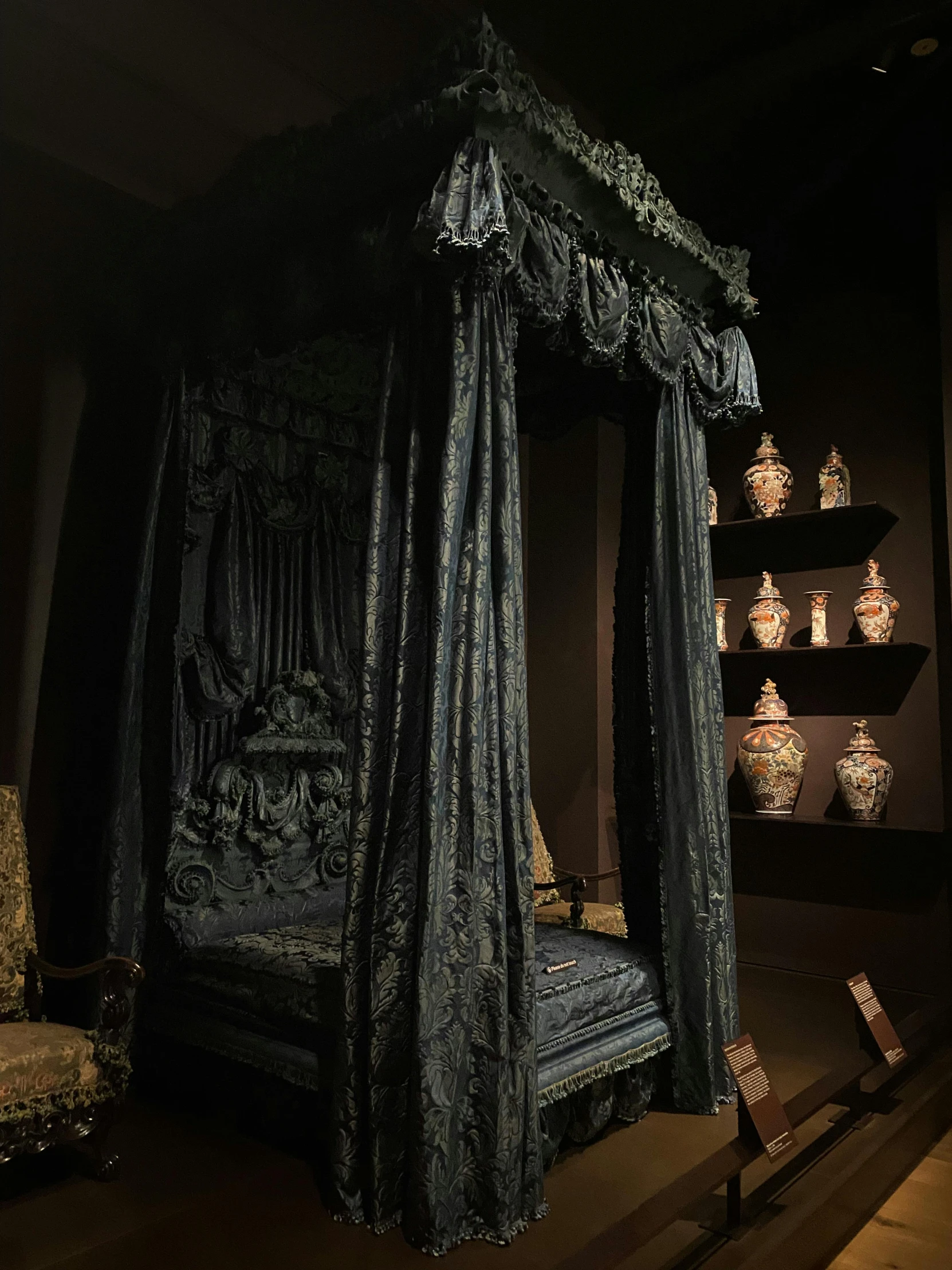 the four poster bed with a gold framed headboard