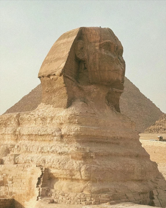 a very big stone sphinx near the pyramids