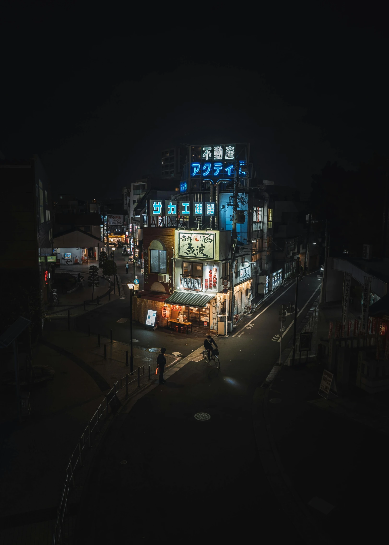 a nighttime time s of buildings and a busy street