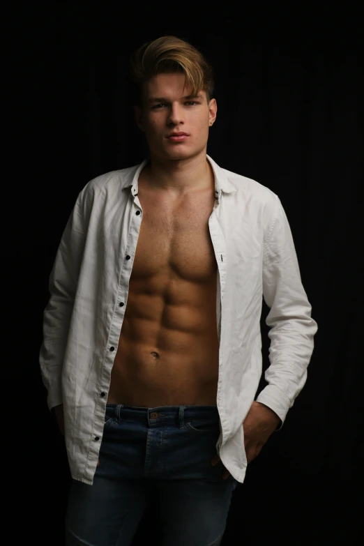 an athletic male wearing a white shirt posing