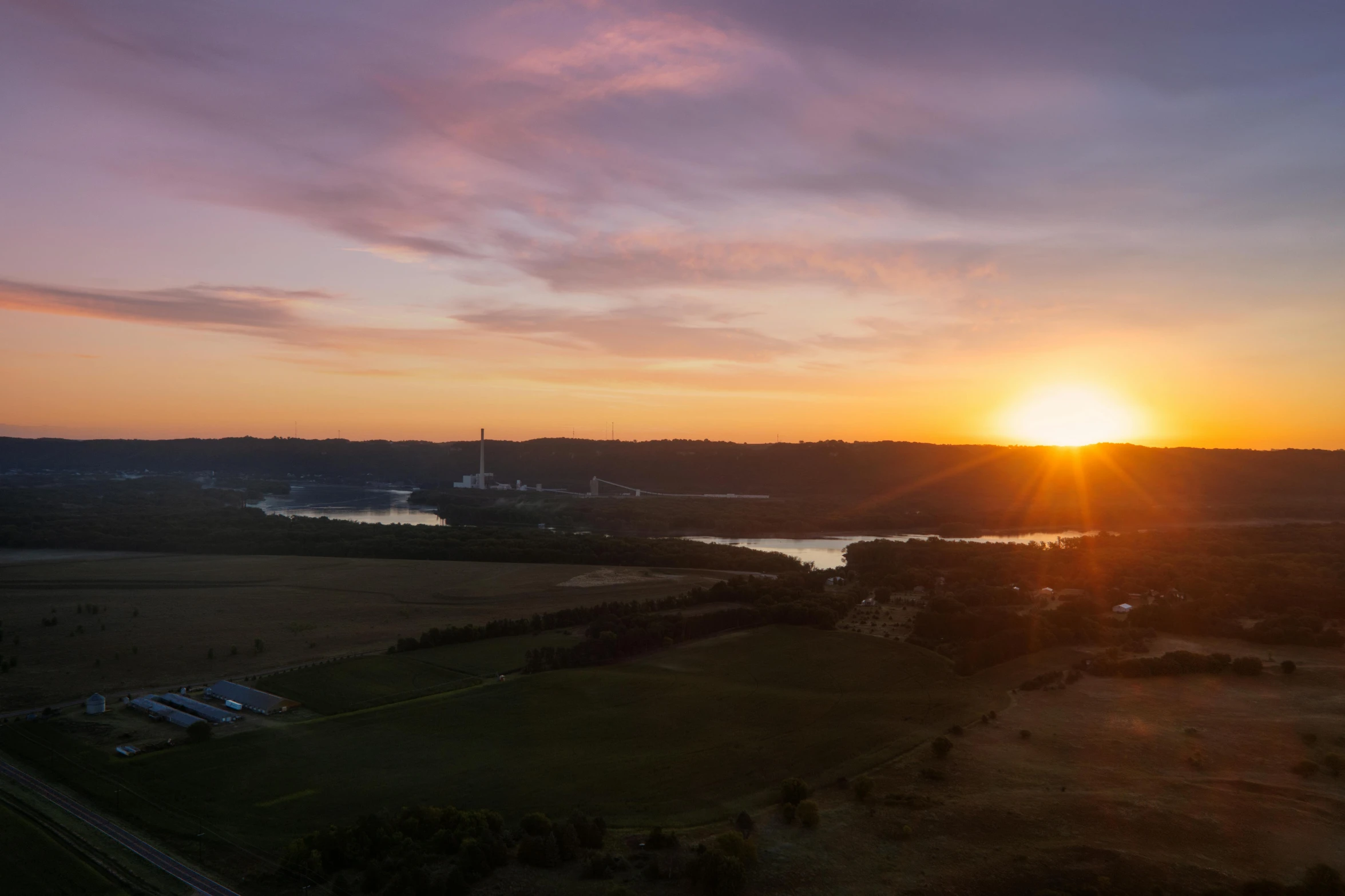 a sun sets over a beautiful prairie landscape