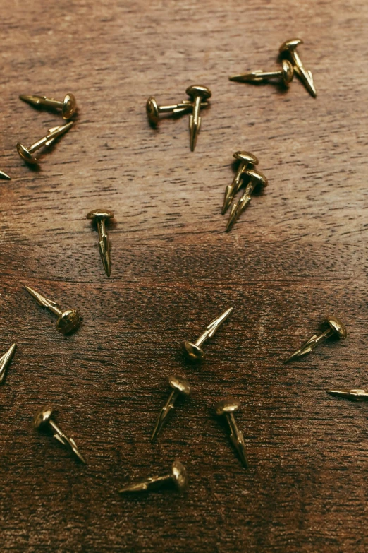 the wooden table is holding many metal objects