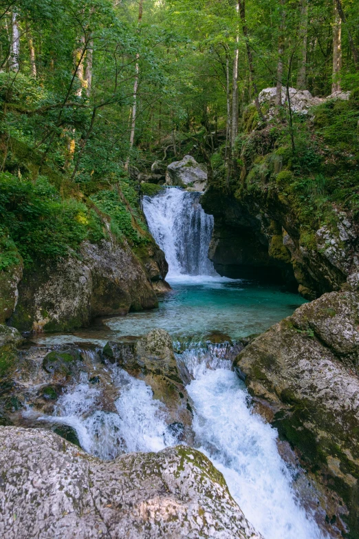 a waterfall is shown in this picture in the woods