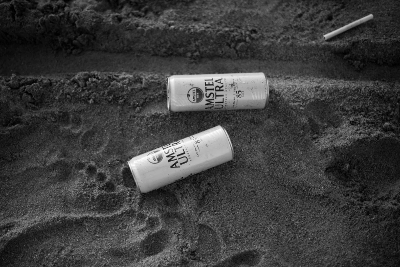 two empty cups lay on a pile of dirt