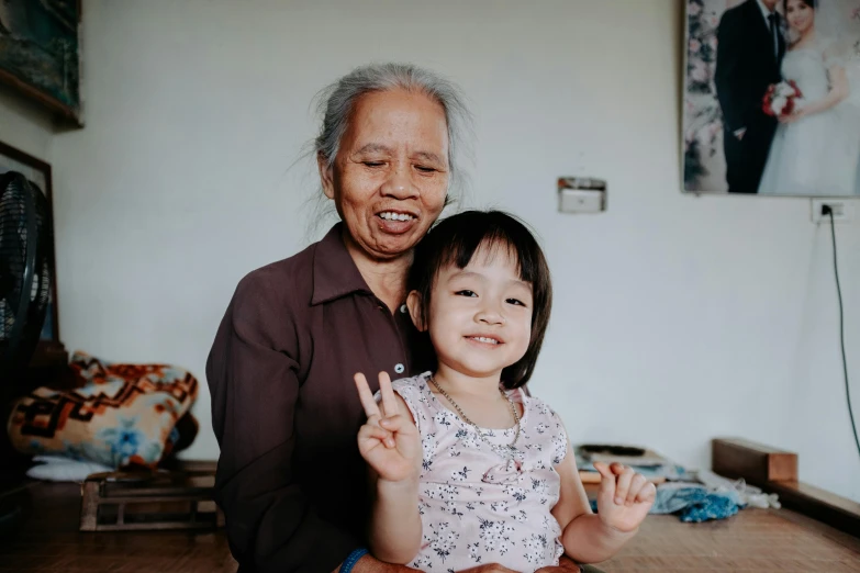 an old man giving the peace sign for a child