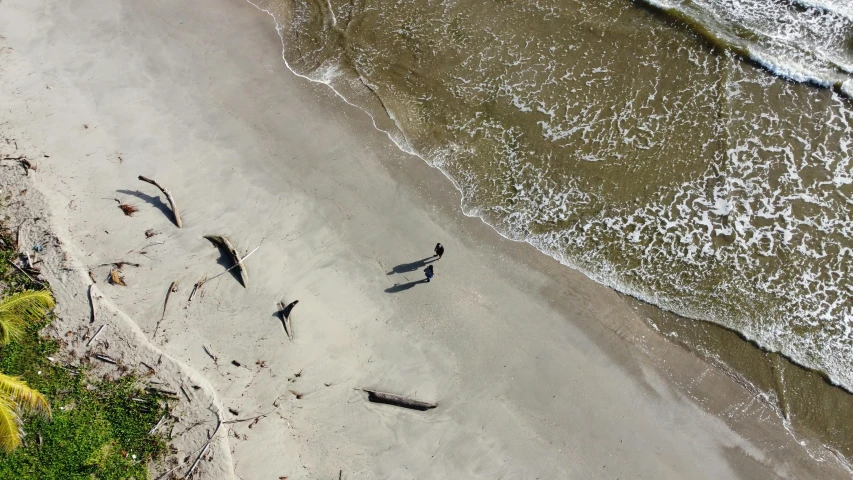 a beach area with sand and water next to the beach