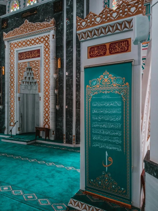 a doorway with a statue inside of it and a green rug