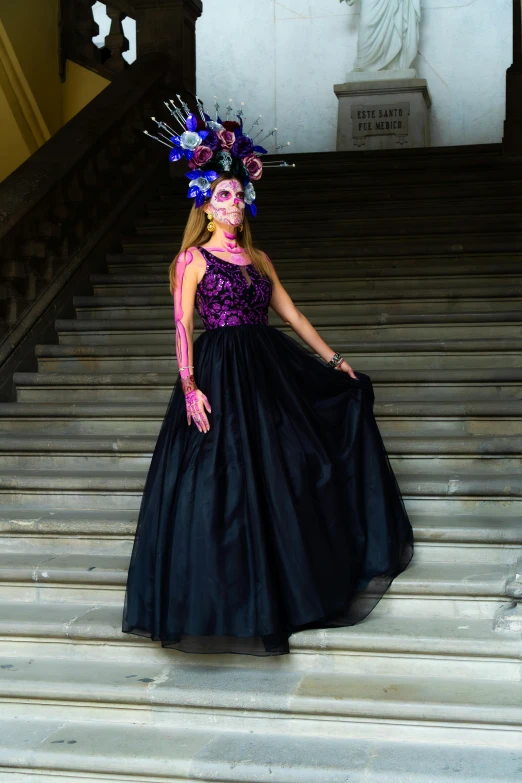 a young woman in costume standing on some stairs