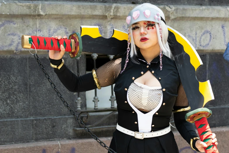 a girl wearing a costume that includes chains, armor and shoes