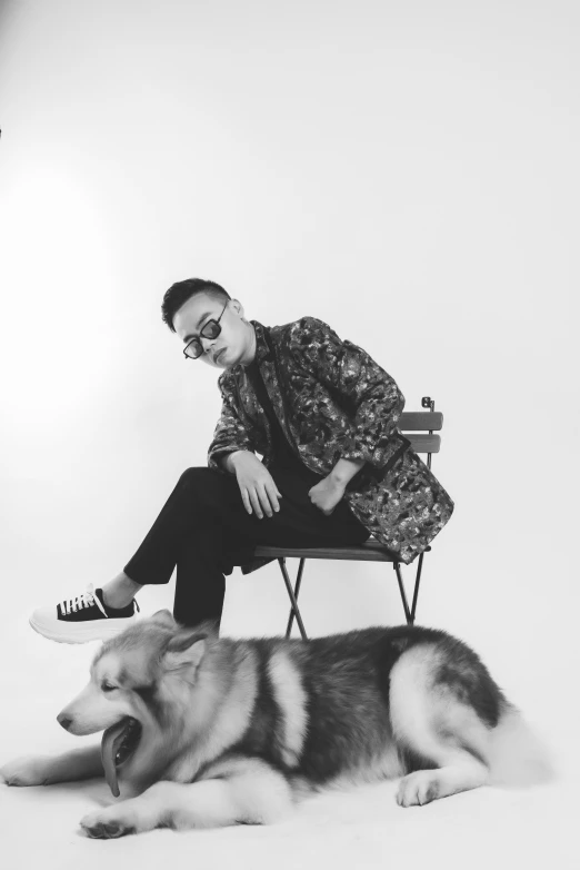 a man sitting next to a large dog