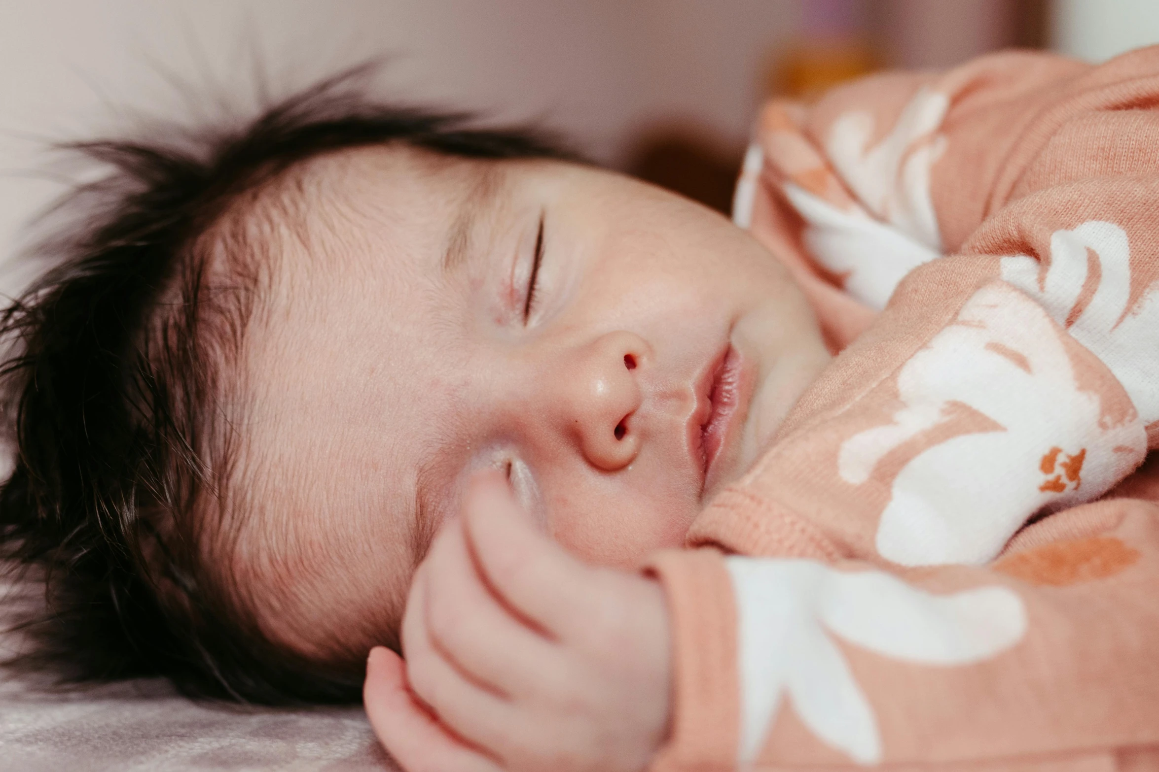 a little boy sleeps on a blanket while laying down