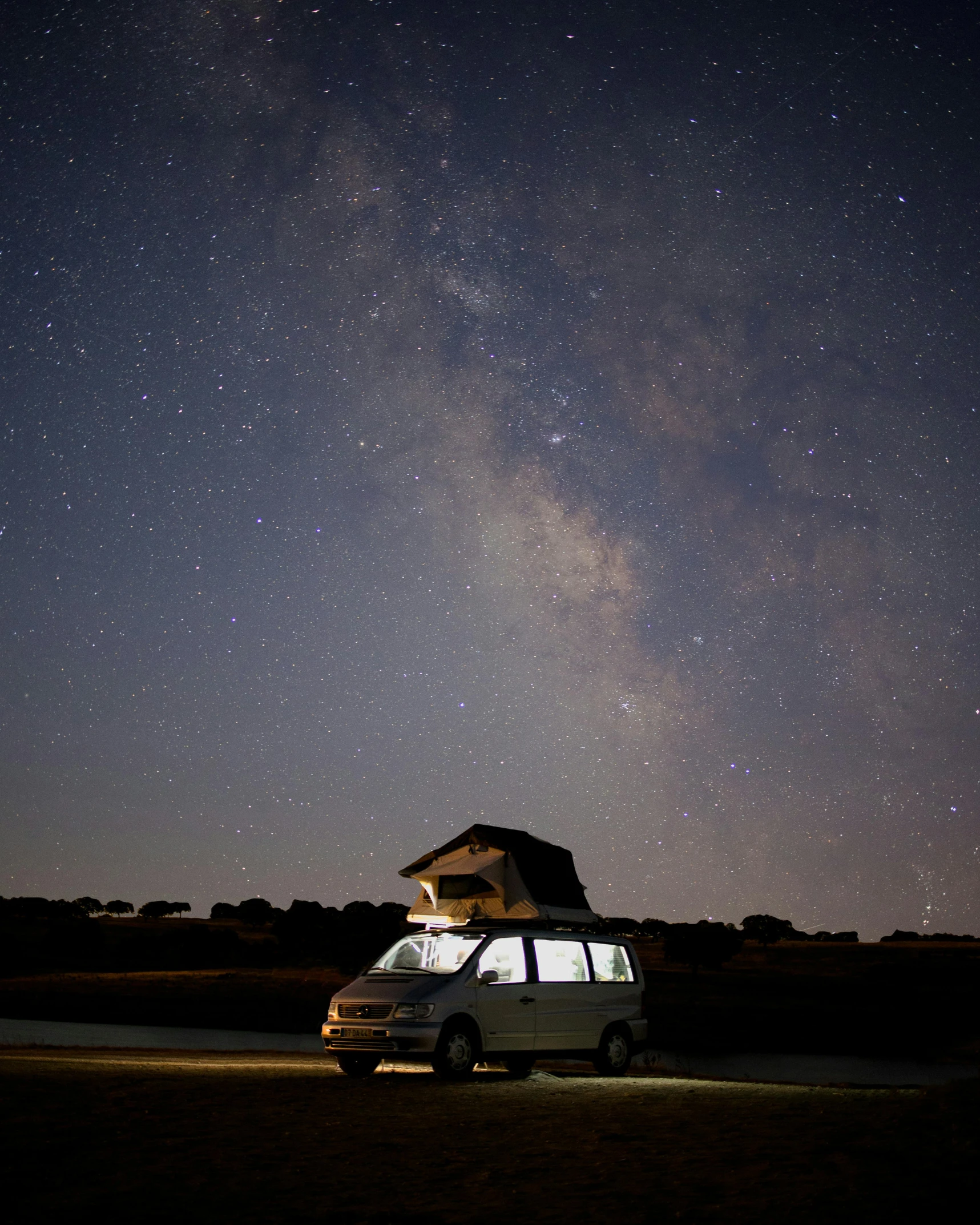 a white van parked in front of a house under the stars