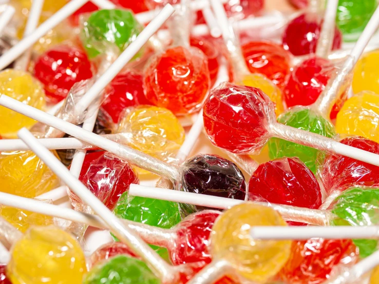 a close up of a pile of many colorful lollipops