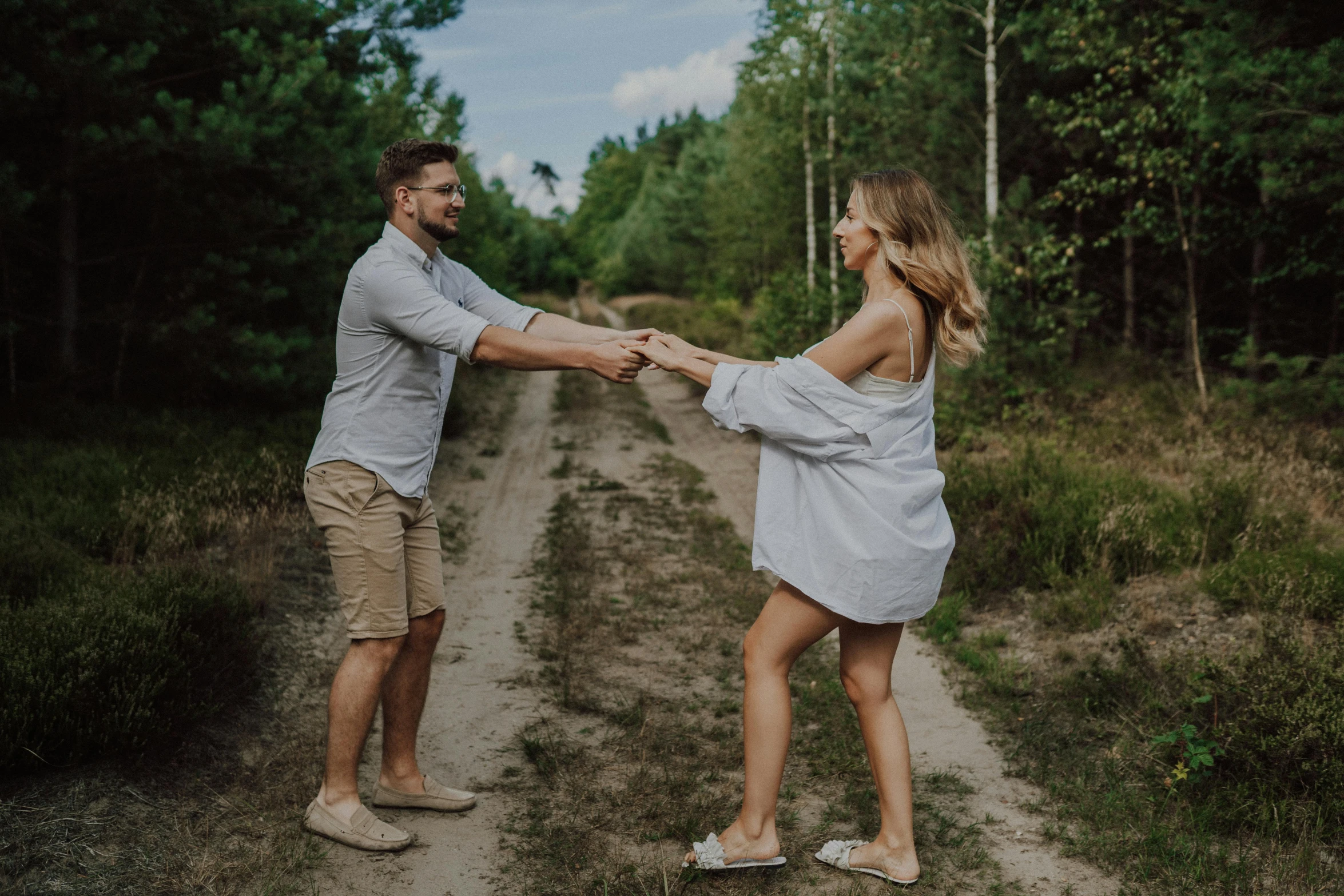 man and woman touching hands on the road while holding each other