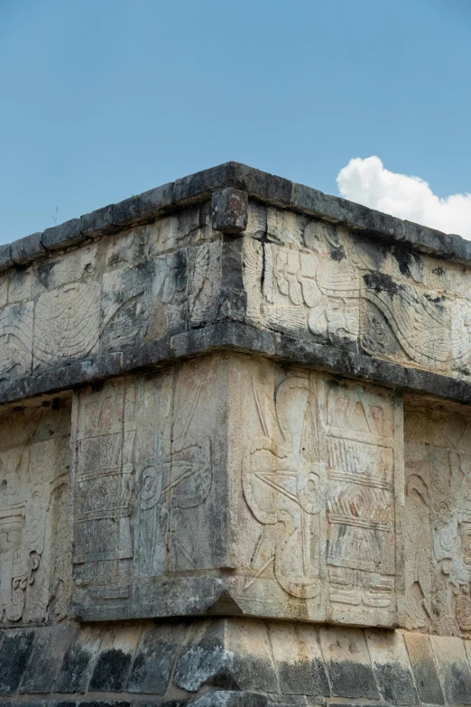 a stone structure with an image of people and animals