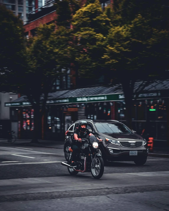 two motorcyclists driving down the road at night