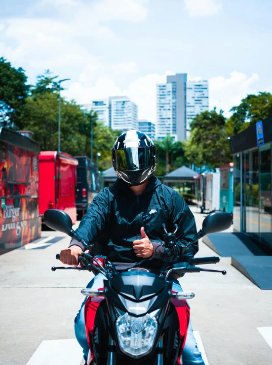 man wearing a black and red helmet riding on a motorcycle