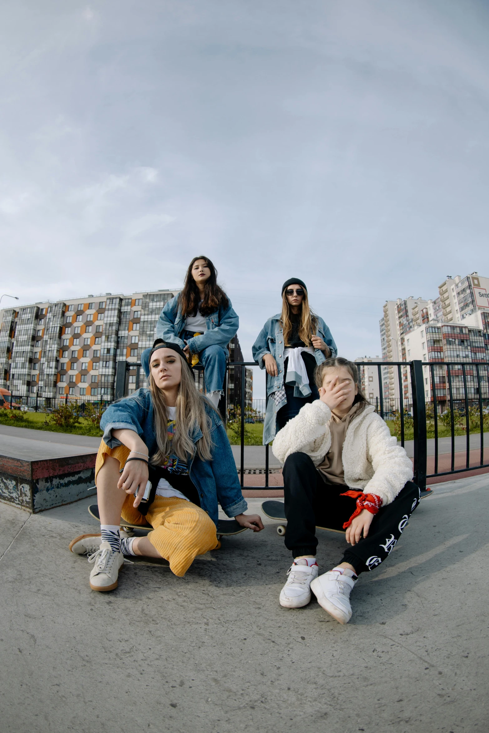 the women are sitting on the ledge and talking