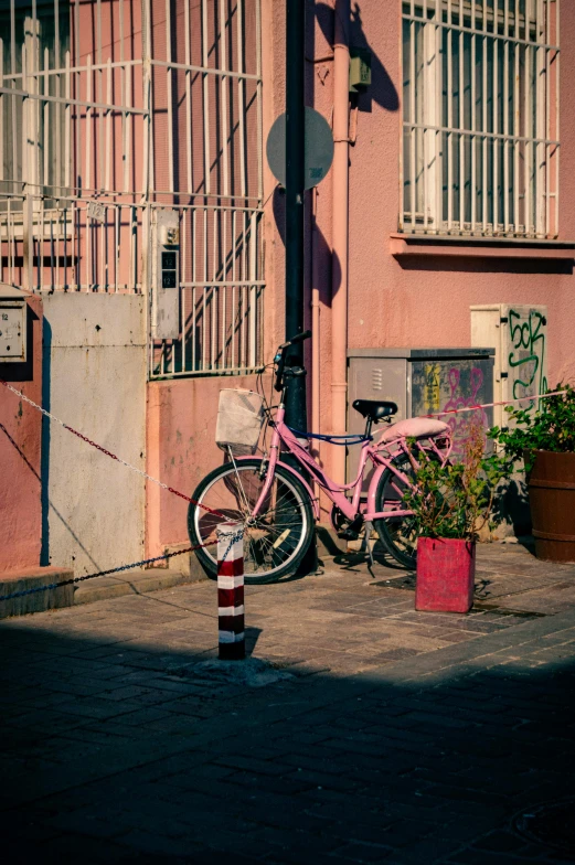 a pink bike sitting on top of a street