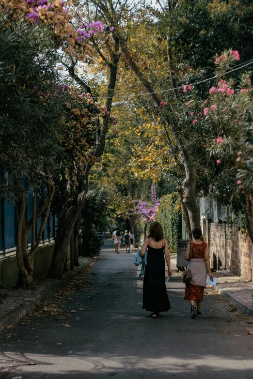 two women walking down the street on foot