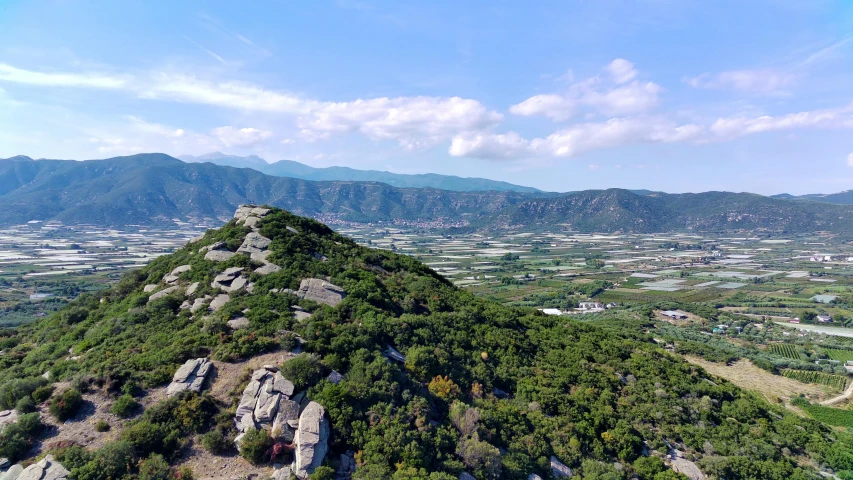 an area with some mountains and houses in the distance