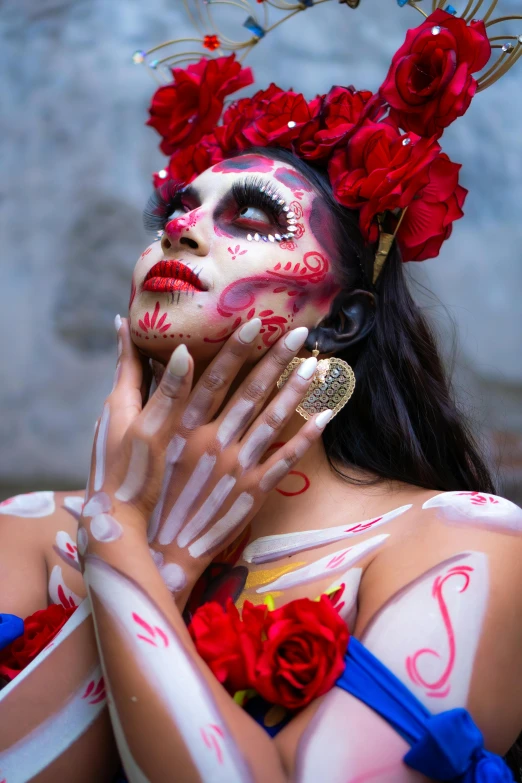 a woman with painted face and hand is posing for the camera