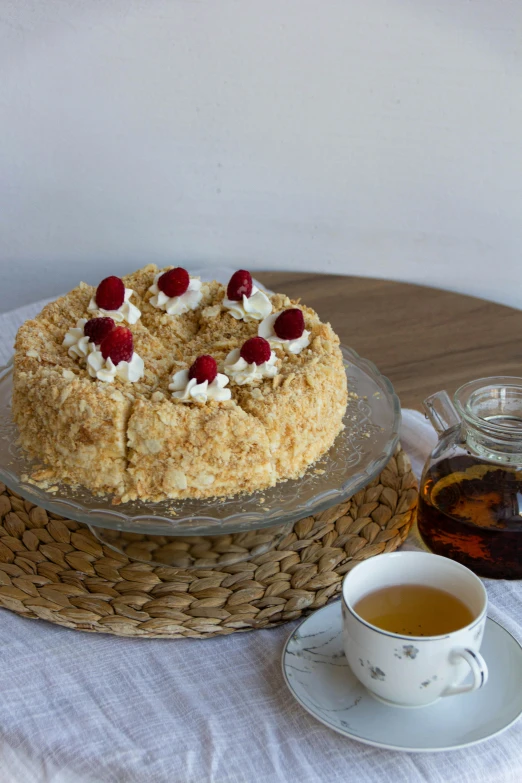 a cake on a table next to a cup