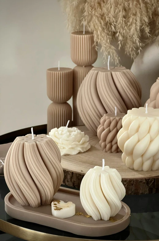 a couple of candles sitting next to each other on top of a table