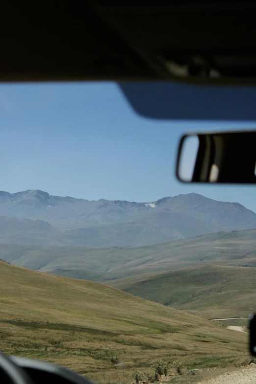 a view from inside a vehicle of the mountains