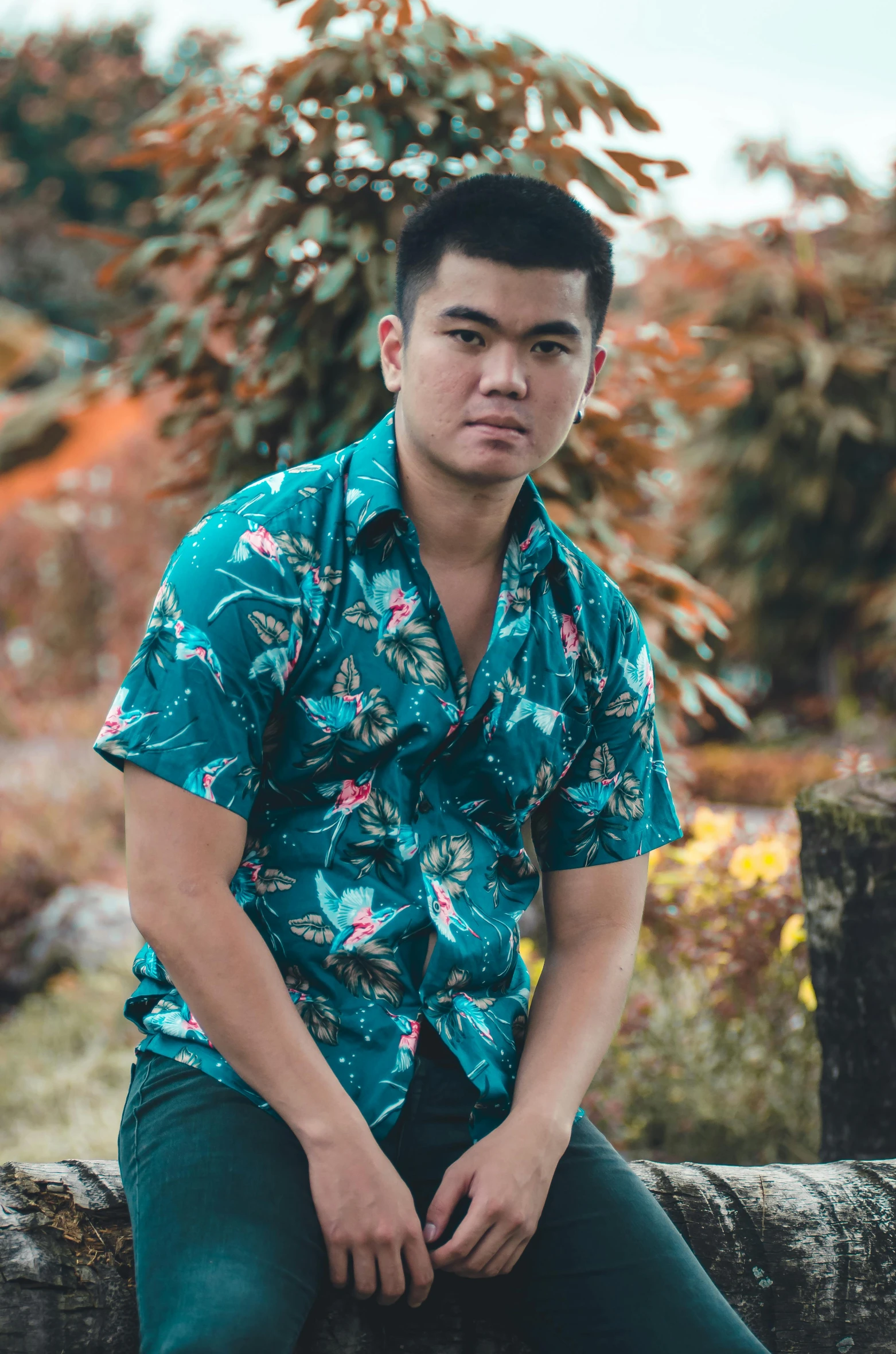 a man in a green flowered shirt sitting down