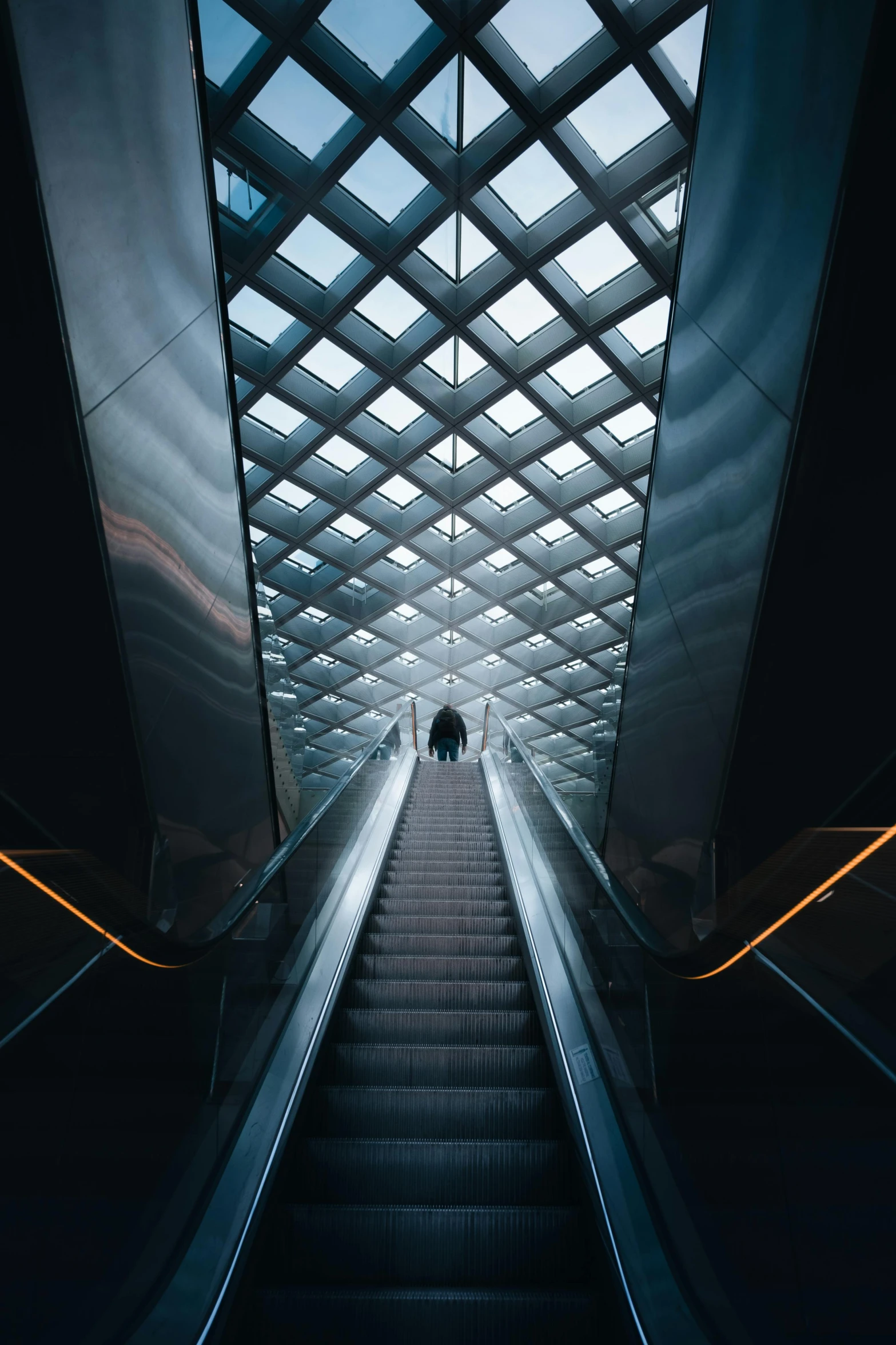 two people on the escalator with a man on one way