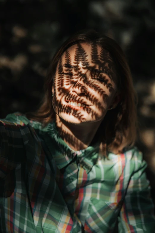 a woman looking down at leaves on her face