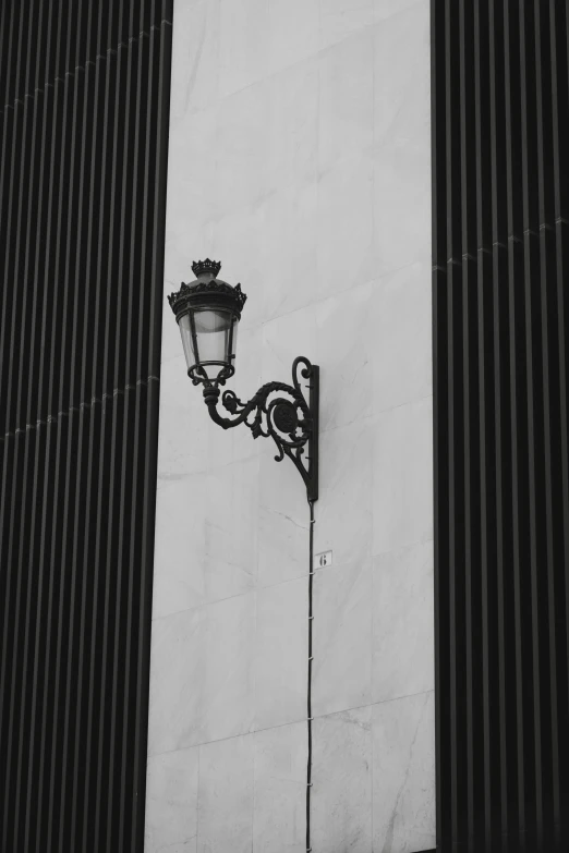 the lamp post stands tall on an unmade wall