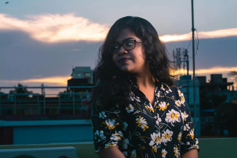 a woman posing for the camera with sky in the background