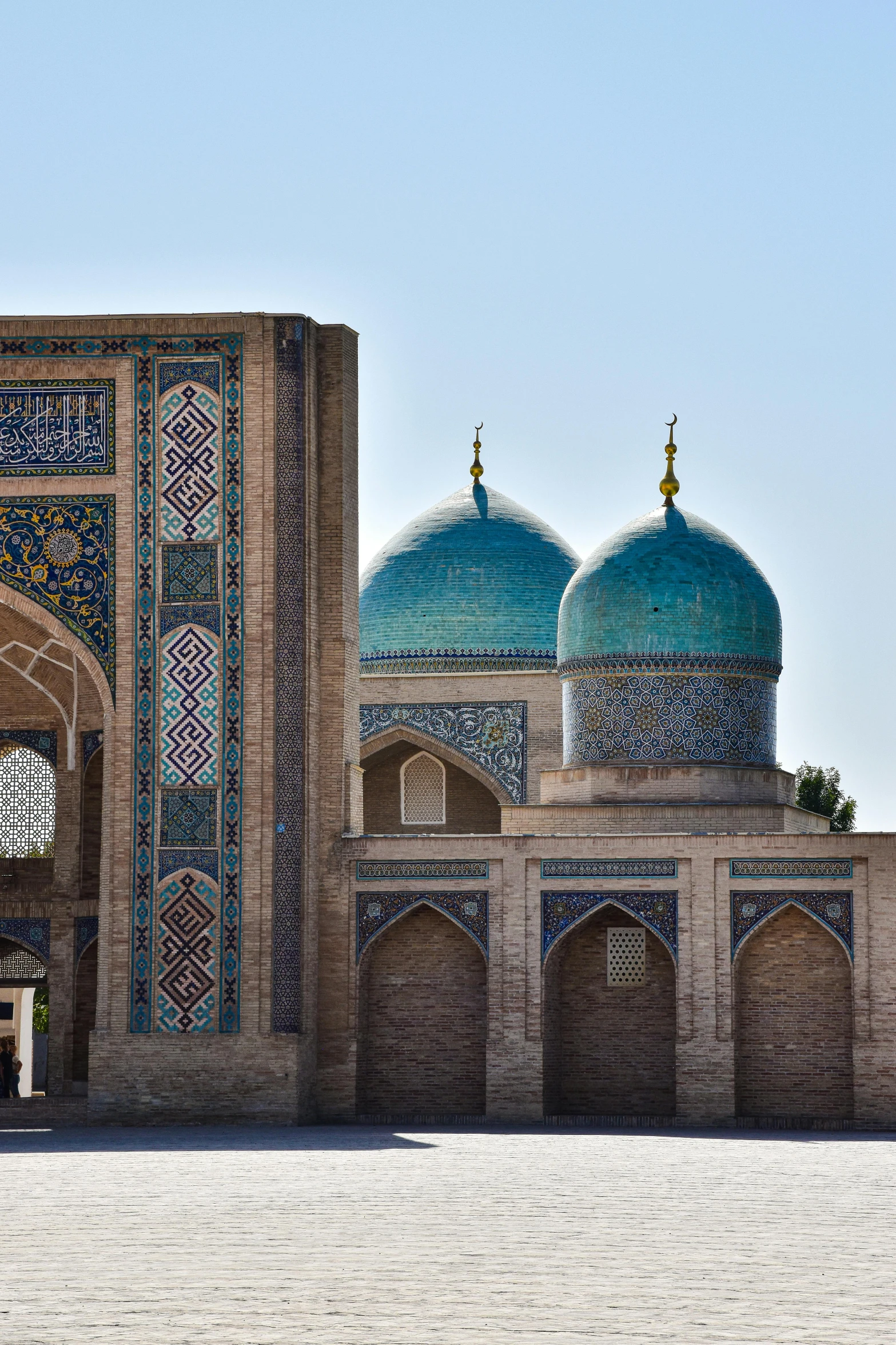 two large archways and a green domed building