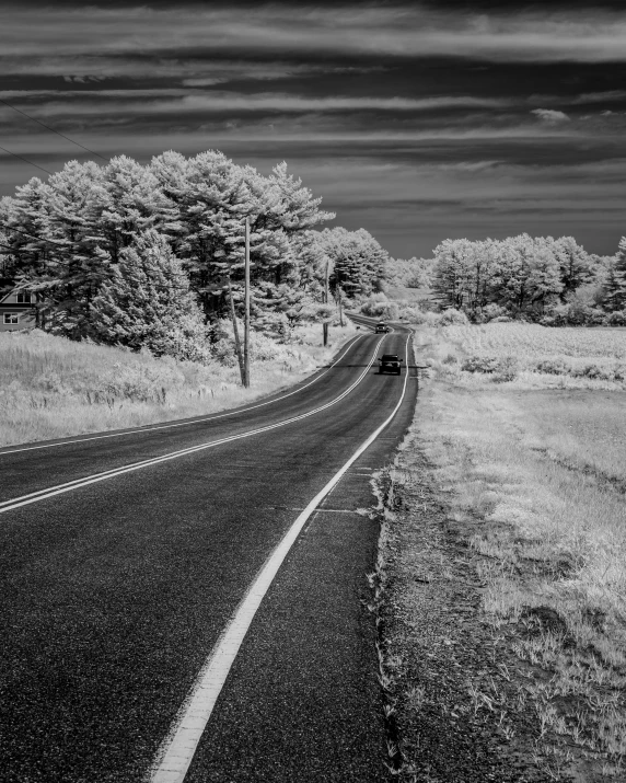 a black and white pograph of an empty road